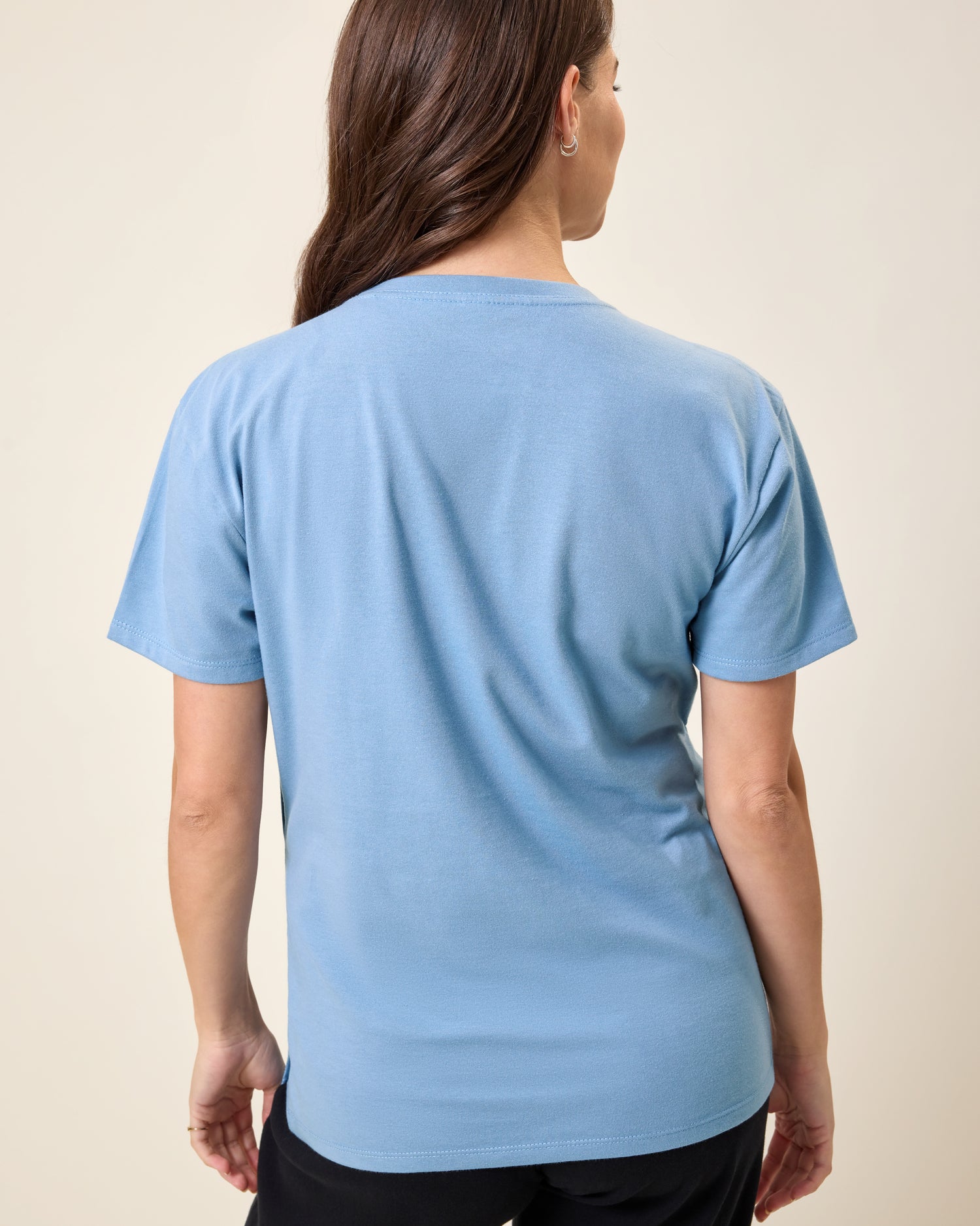 Back view of model wearing Relaxed Cotton Maternity & Nursing T-shirt in Vintage Blue on a neutral background