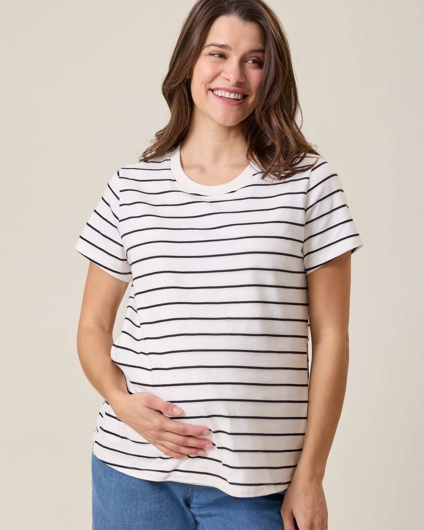 Front view of model wearing Classic Cotton Nursing T-shirt in White & Black Stripe on a neutral background@model_info:Elliana is wearing a Medium.