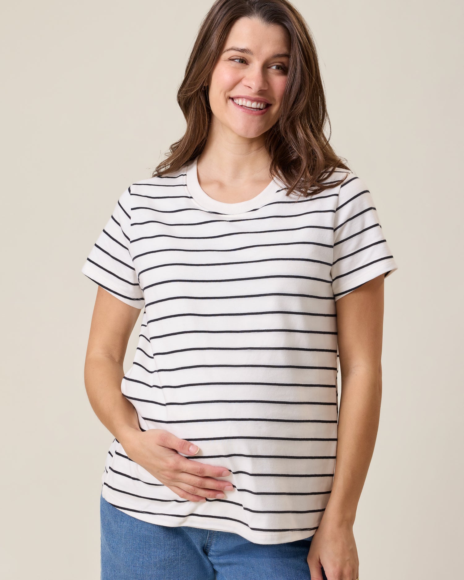 Front view of model wearing Classic Cotton Nursing T-shirt in White & Black Stripe on a neutral background@model_info:Elliana is wearing a Medium.