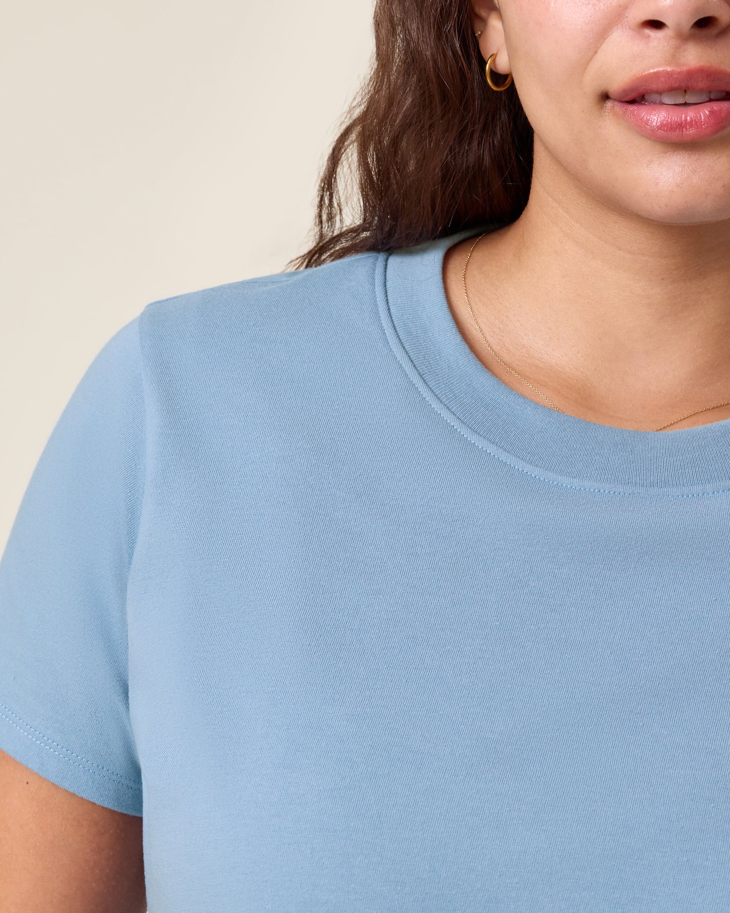 Close up of model wearing Classic Cotton Nursing T-shirt in Vintage Blue on a neutral background