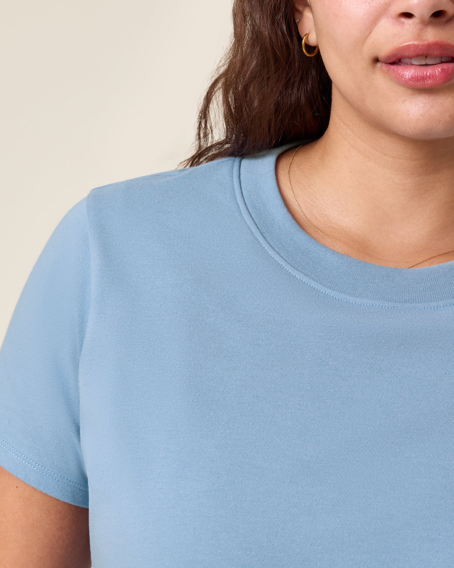 Close up of model wearing Classic Cotton Nursing T-shirt in Vintage Blue on a neutral background