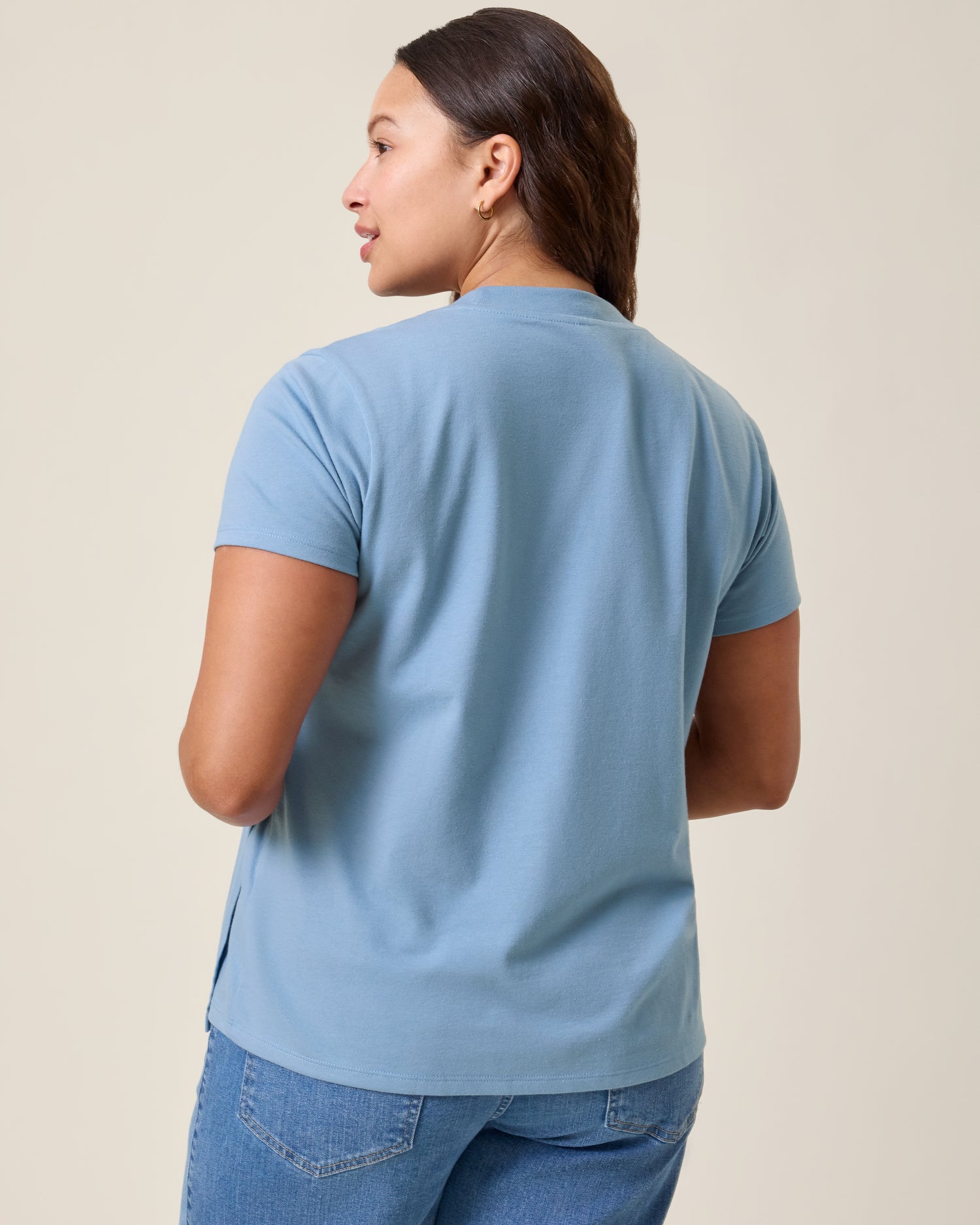 Back view of model wearing Classic Cotton Nursing T-shirt in Vintage Blue on a neutral background