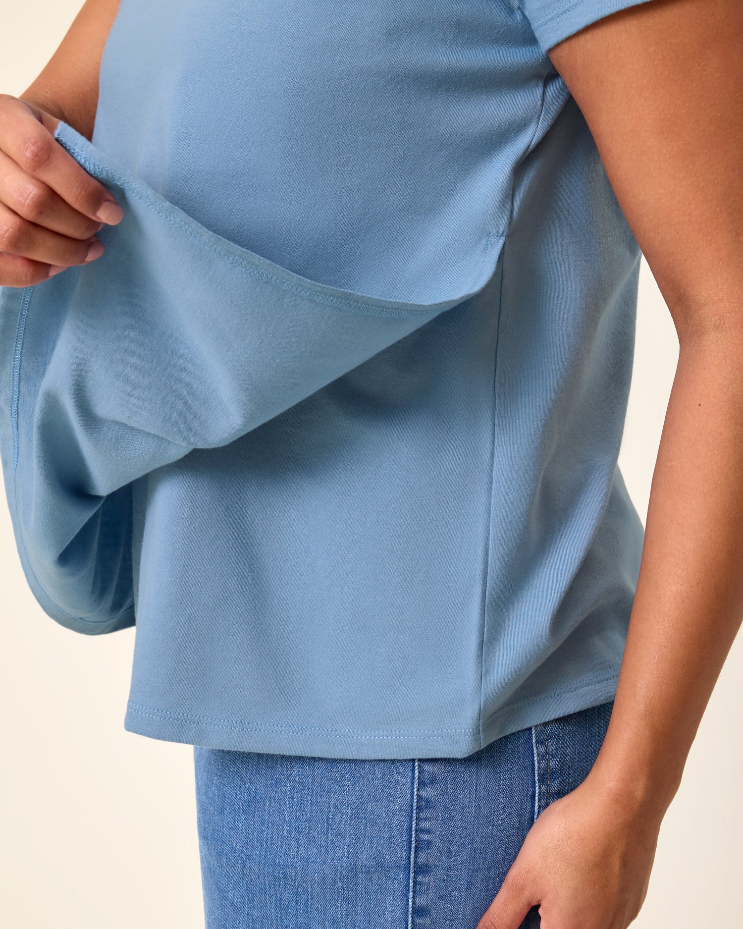 Close up of model wearing Classic Cotton Nursing T-shirt in Vintage Blue showing how the front panel lifts up for breastfeeding access
