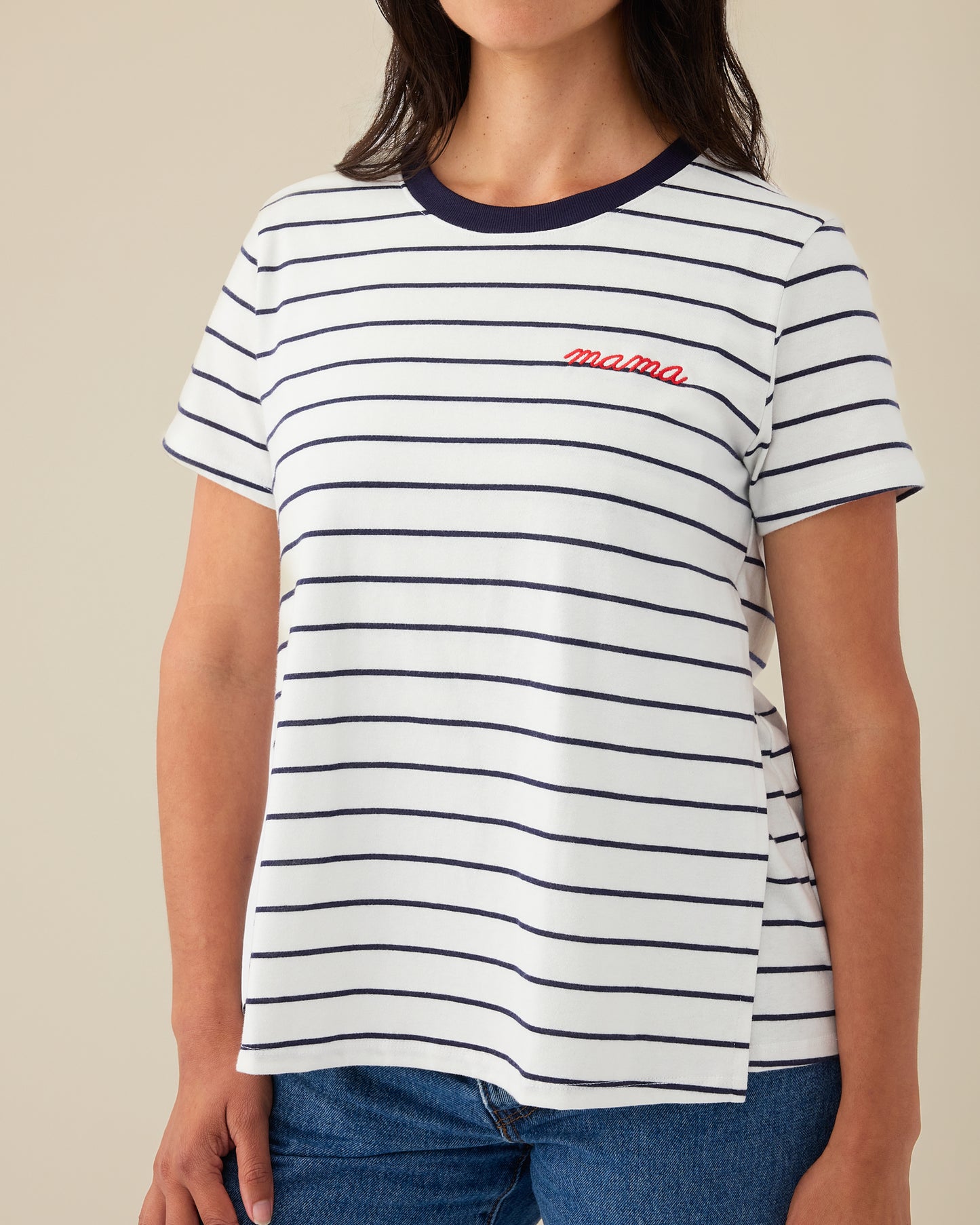 Model is wearing Classic Cotton Nursing T-shirt in Navy & White Stripe - Embroidered, with the red-threaded word, mama, on a beige background.@model_info:Karina is wearing a Small.
