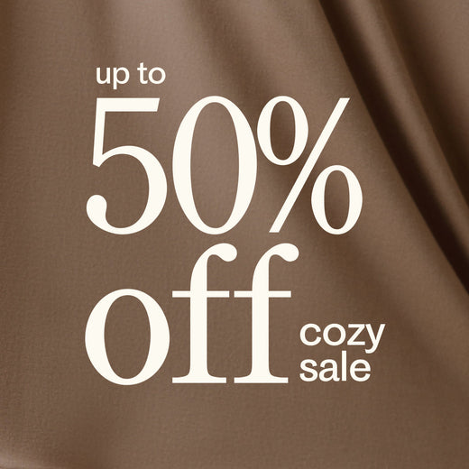 Promotional text 'up to 50% off cozy sale' on a brown background