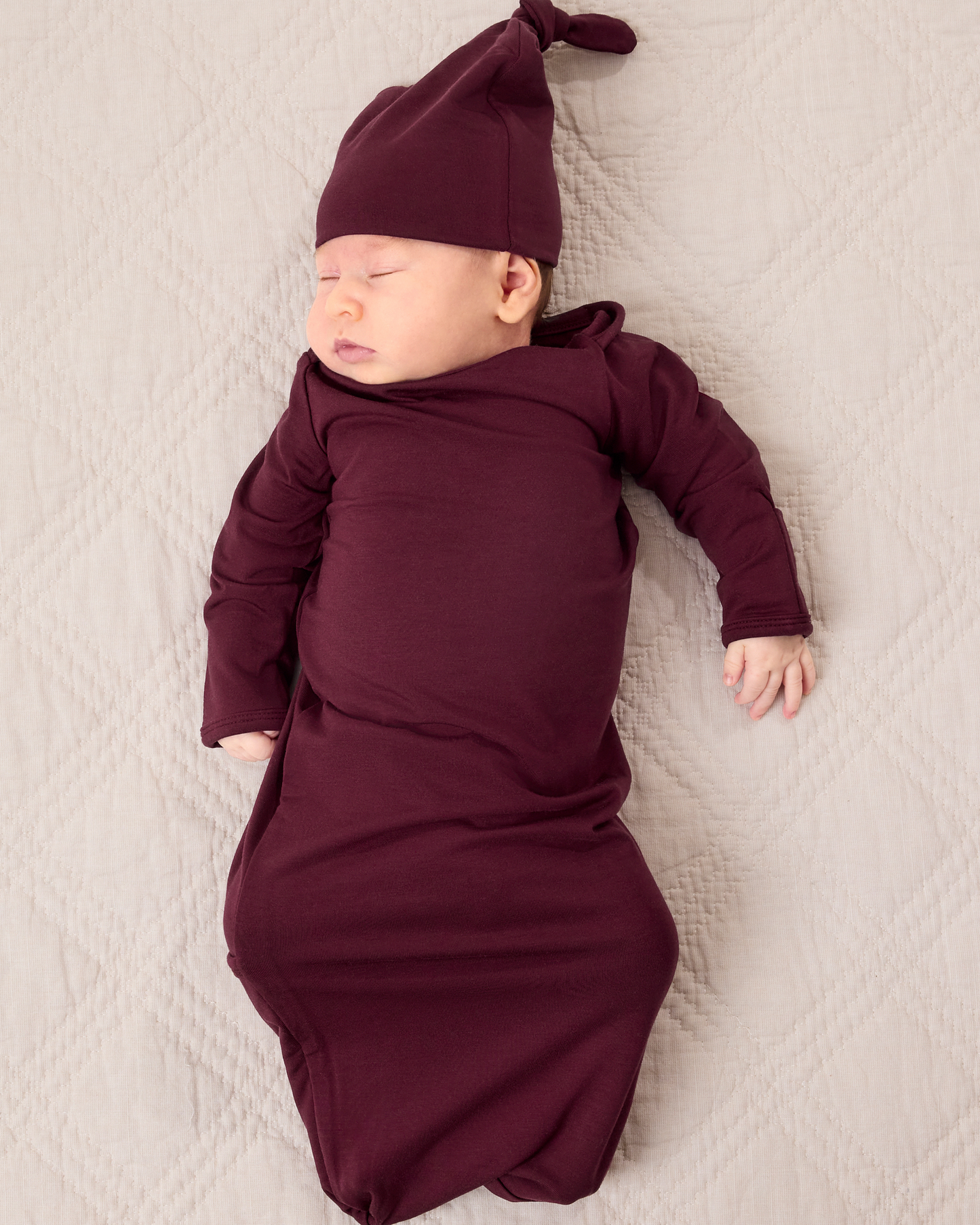 Baby wearing the Cozy Bamboo Baby Gown & Hat in Deep Burgundy@model_info:Liora is 5 weeks old.
