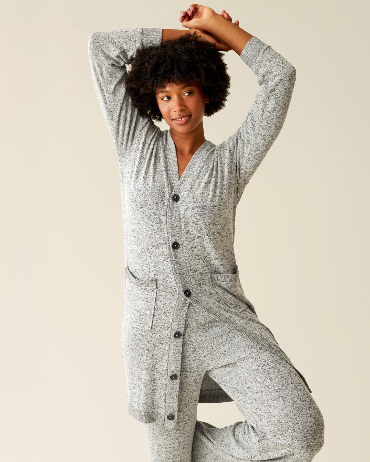 Front view of model with her arms up wearing CozyKnit Long Cardigan in Grey Heather@model_info:Kyra is 5'9" and wearing a Small.