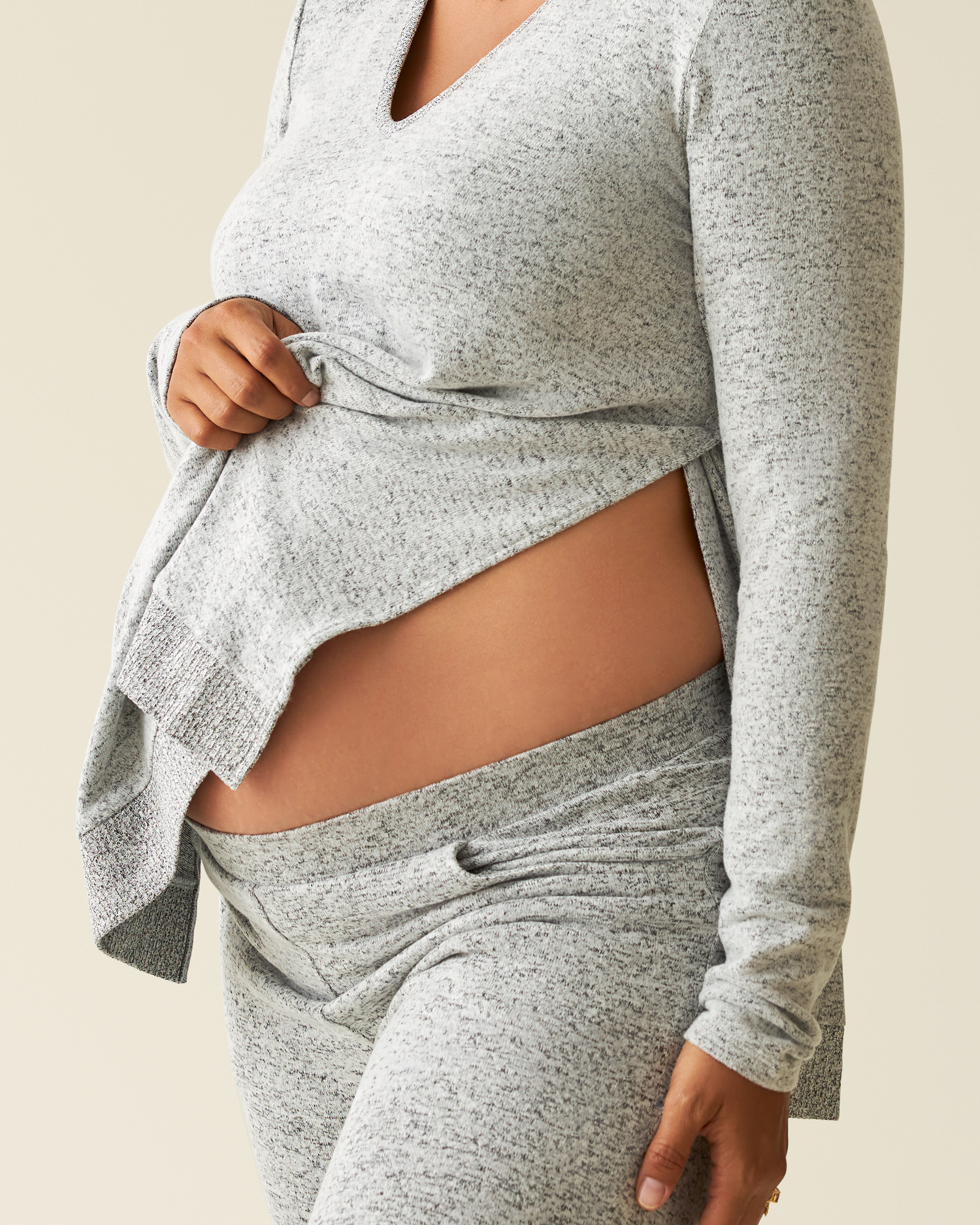 Pregnant model showing side opening of CozyKnit Maternity & Nursing V-neck Top in Heathered Grey with matching pants