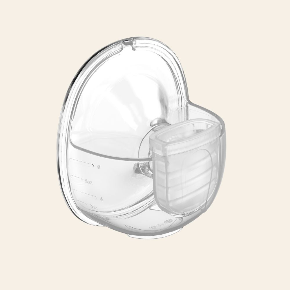 Breastmilk collection cup (6oz) of the Lansinoh - Discreet Duo™ Wearable Pump on a beige background.