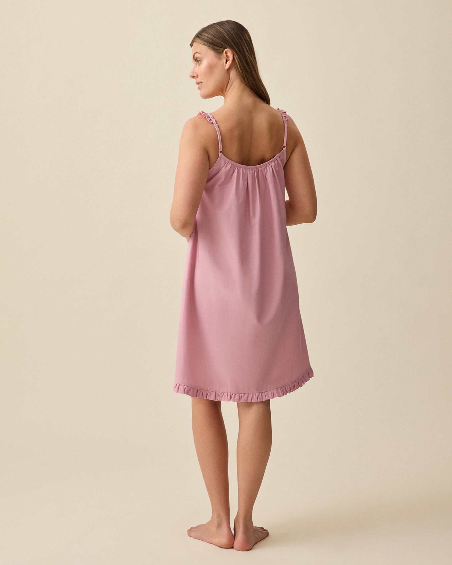 Model displaying back view of Dreamy Cotton Maternity & Nursing Nightgown in Light Mauve on a beige background