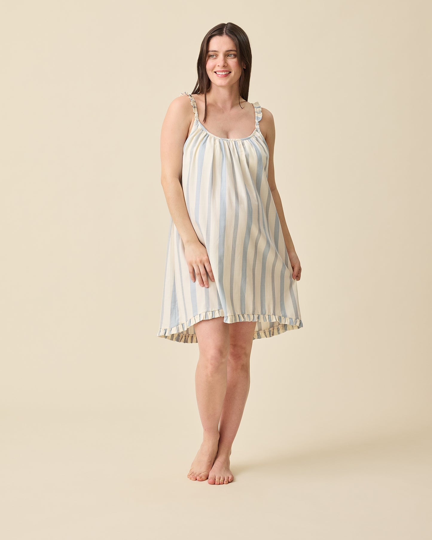 Model wearing Dreamy Cotton Maternity & Nursing Nightgown in Vintage Blue Stripe on a beige background