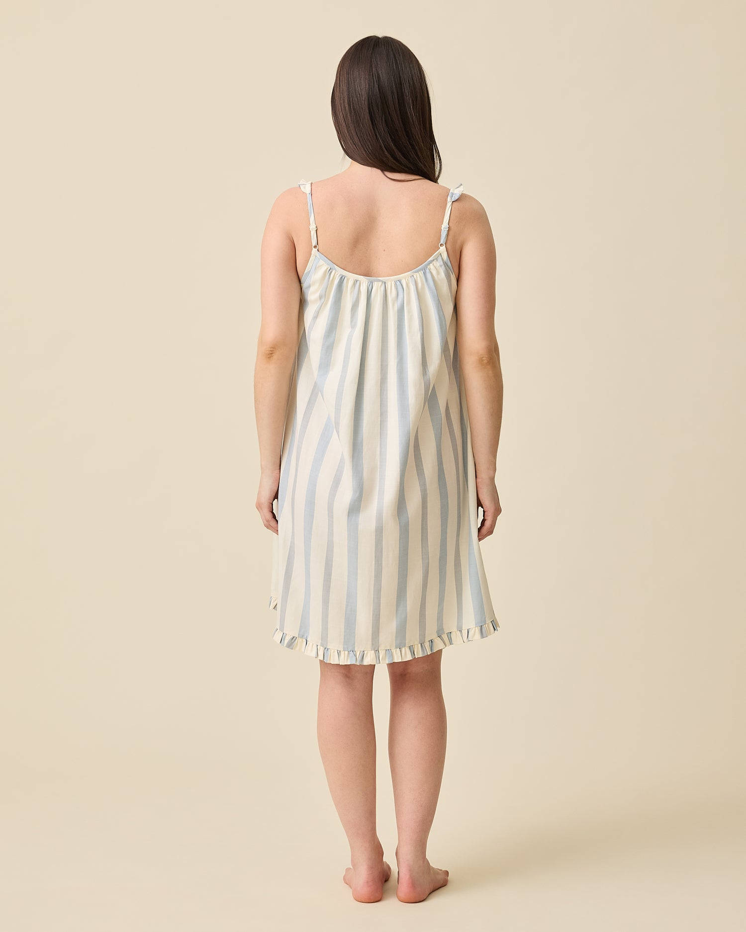 Model displaying back view Dreamy Cotton Maternity & Nursing Nightgown in Vintage Blue Stripe on a beige background
