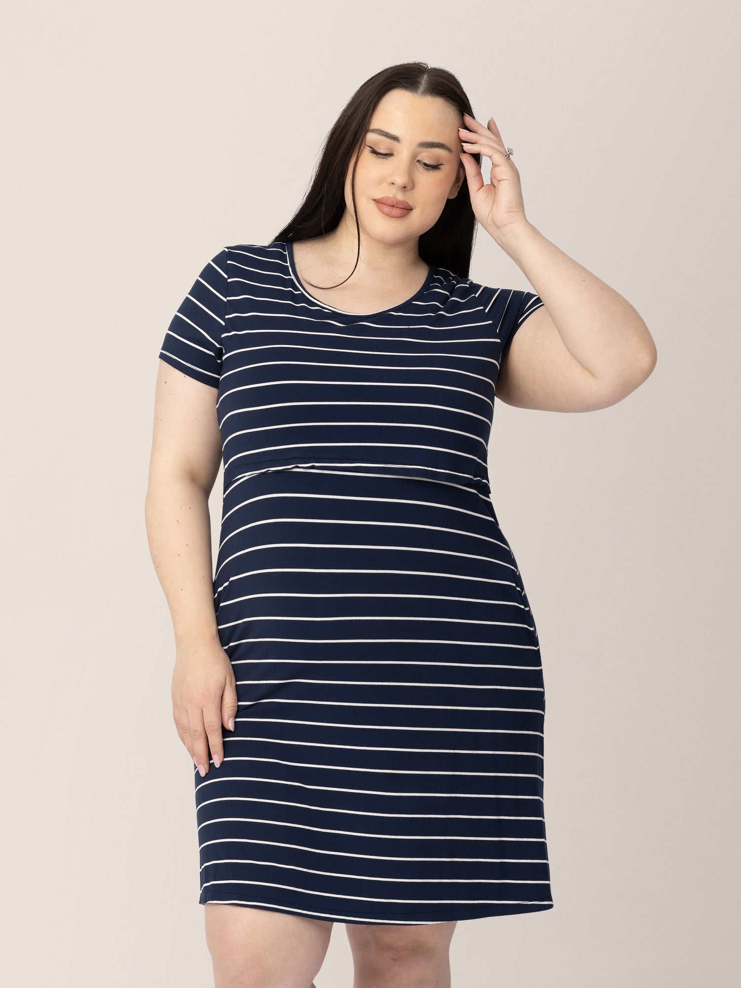 Model wearing the Eleanora Bamboo Maternity & Nursing Dress in Navy Stripe @model_info:Rachel is 5'6" and wearing an X-Large. 