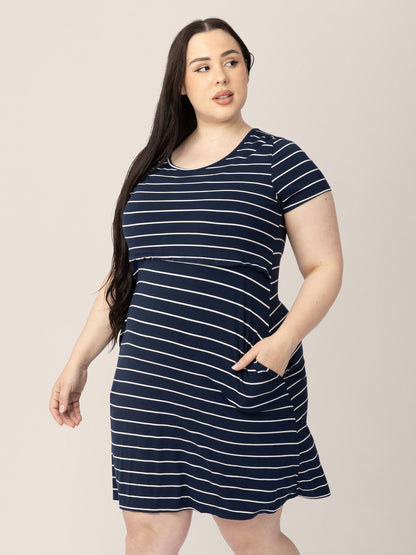 Model wearing the Eleanora Bamboo Maternity & Nursing Dress in Navy Stripe with one hand in her pocket. 