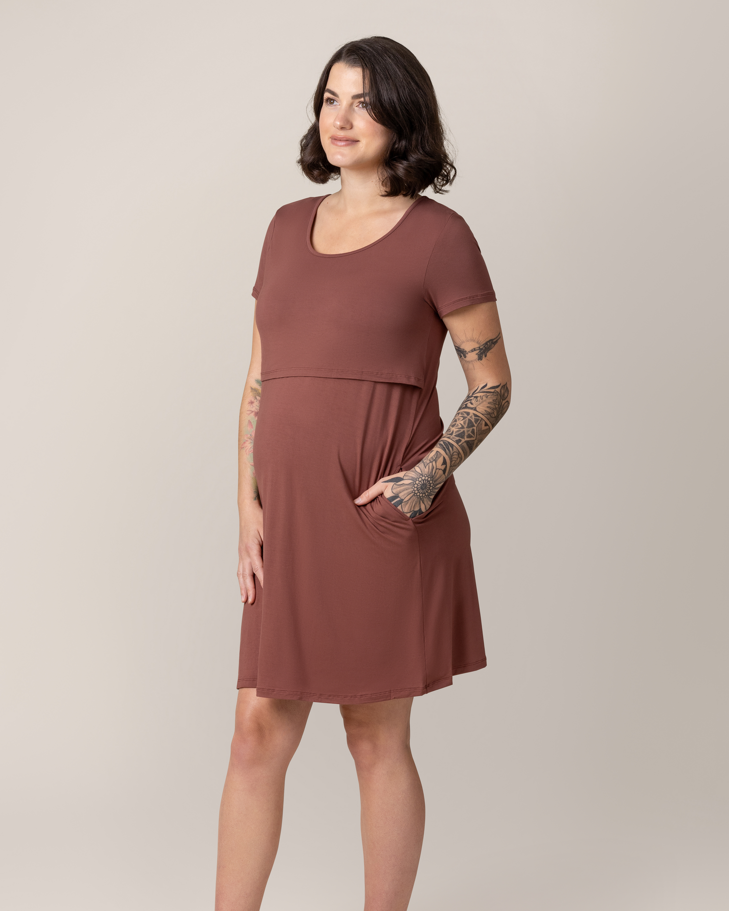 Model wearing the Eleanora Bamboo Maternity & Nursing Dress in Redwood, with hand in pocket 