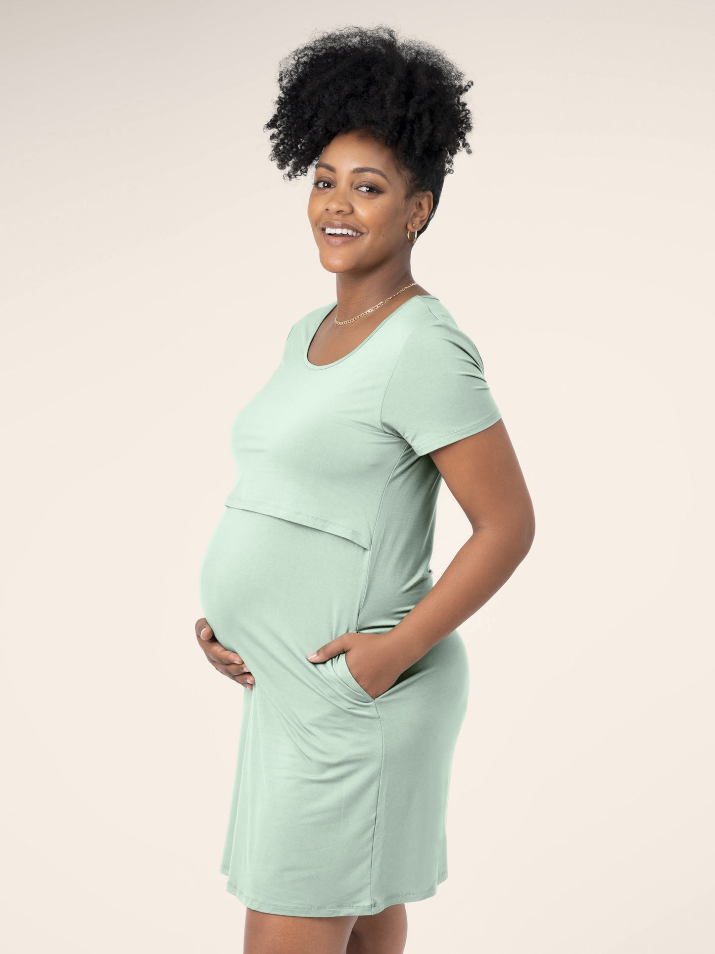 Side view of model wearing the Eleanora Bamboo Maternity & Nursing Dress in soft mint, with hand in pocket