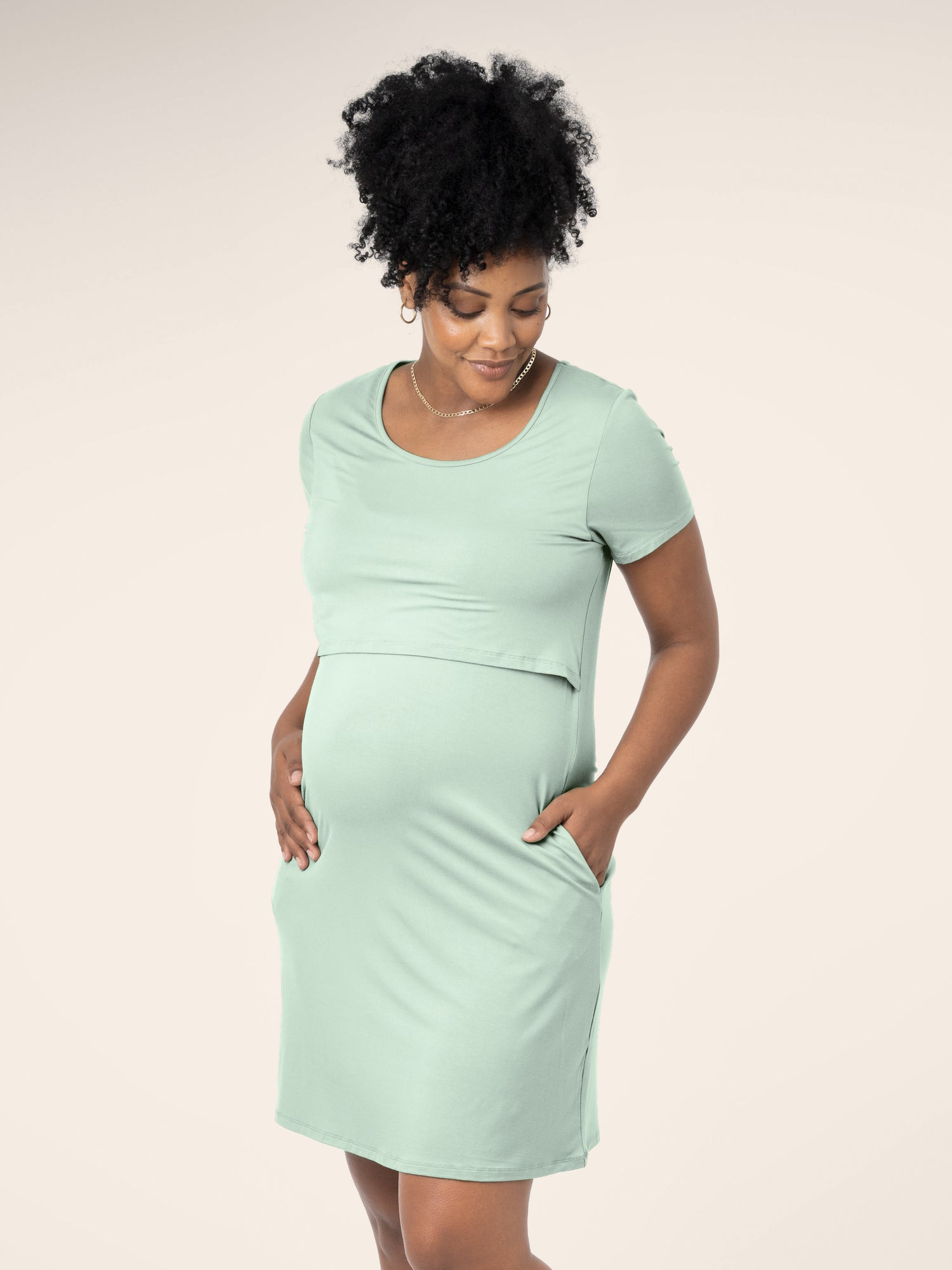 Front view of model wearing the Eleanora Bamboo Maternity & Nursing Dress in soft mint, with hand in pocket @model_info:Roxanne is 5'8" and wearing a Large.
