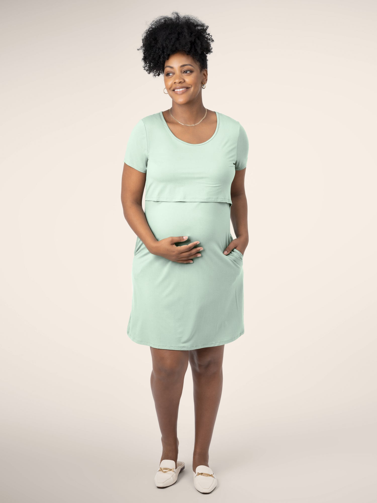 Full view of model wearing the Eleanora Bamboo Maternity & Nursing Dress in soft mint with hand in pocket