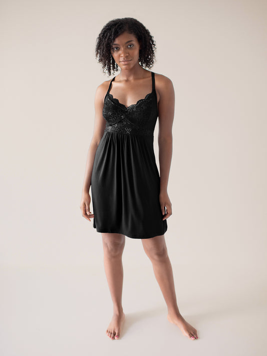 Model wearing the Ella Lace Nightgown in Black with her hands at her sides. @model_info:Kaelani is wearing a Medium.
