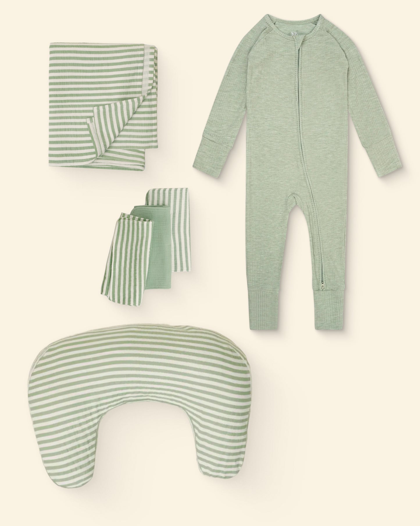 Set of green and white stripe patterned nursing pillow, burp cloths, swaddle and baby onesie on a light background