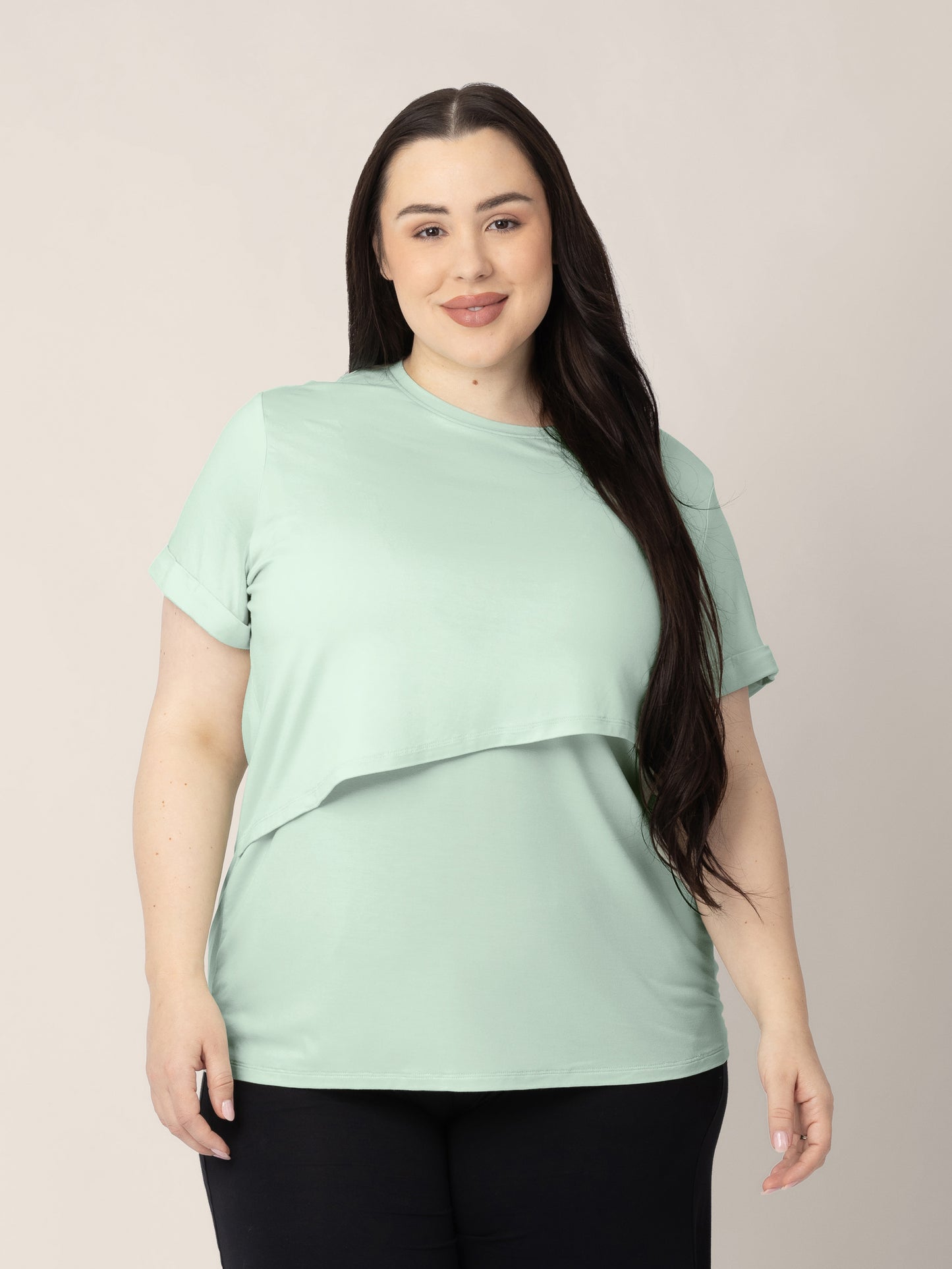 Front view of a model wearing the Everyday Asymmetrical Nursing T-shirt in Soft Mint @model_info:Rachel is wearing an X-Large.