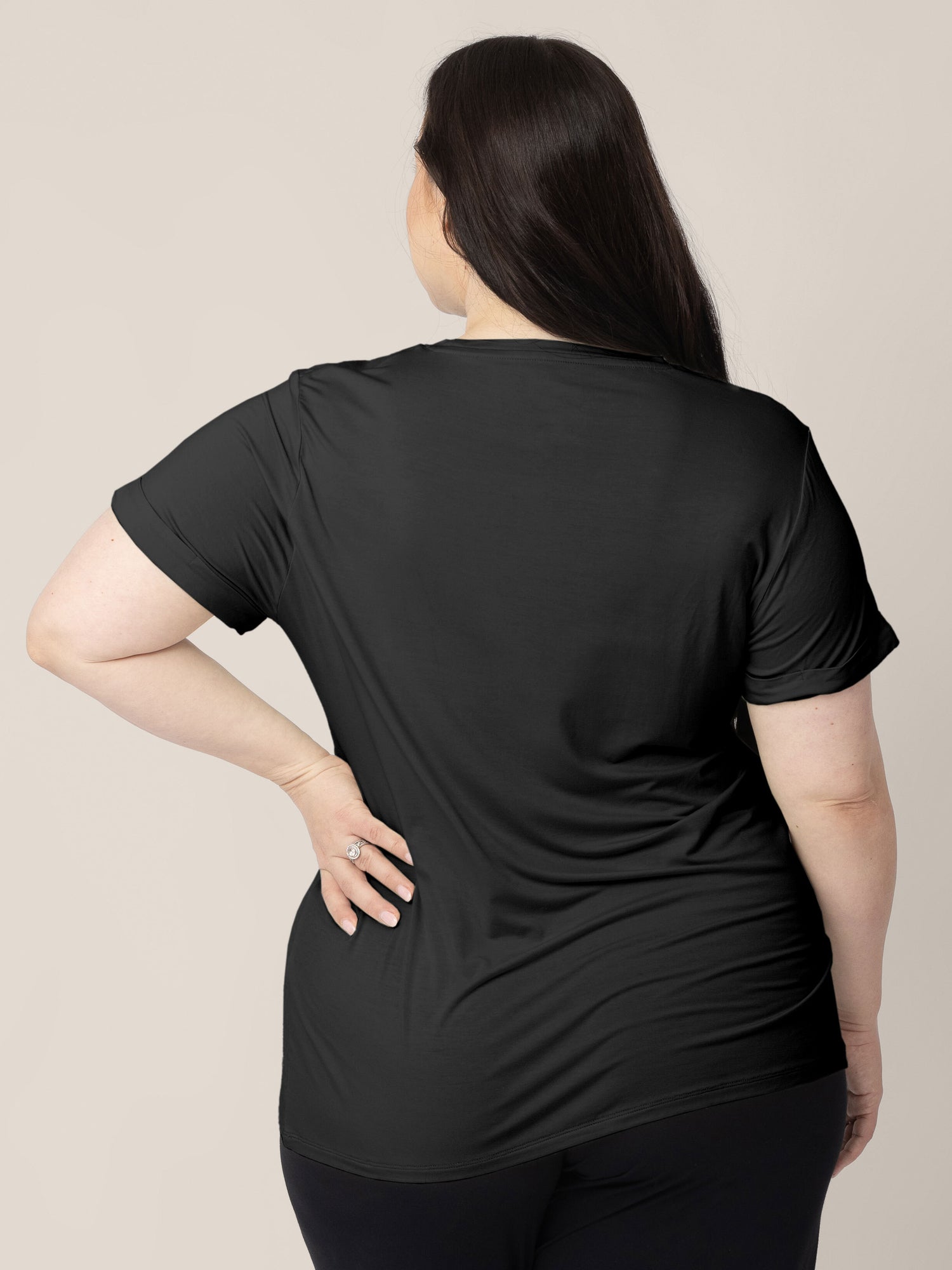 Back view of a model wearing the Everyday Asymmetrical Nursing T-shirt in Black