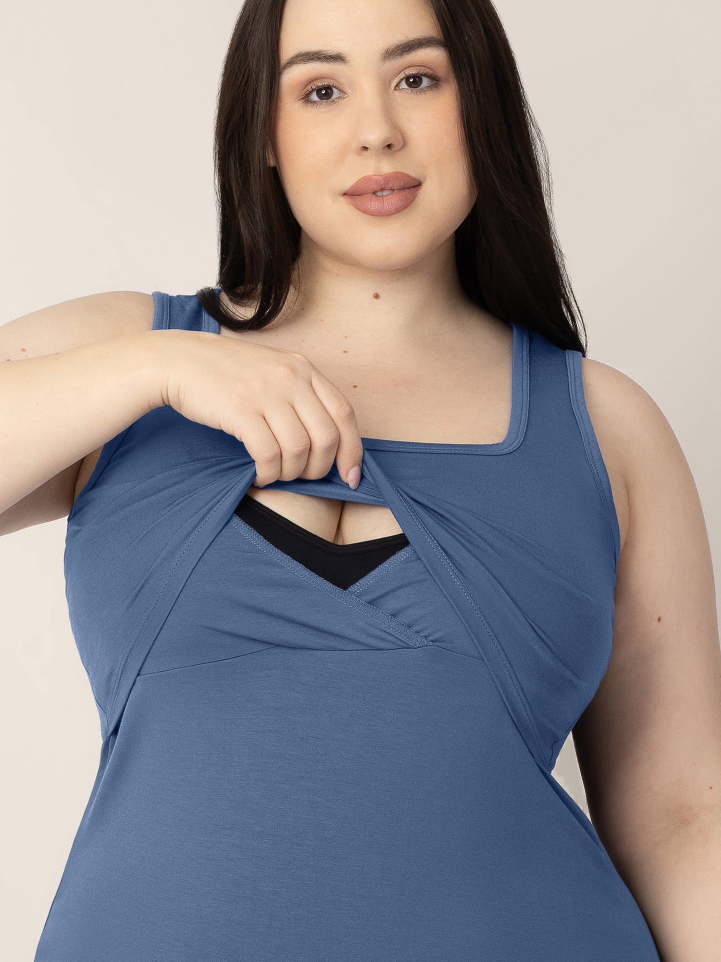 Front view of a model wearing the Everyday Essential Nursing Tank in Slate Blue showing the pull up nursing panel for easy breastfeeding access 