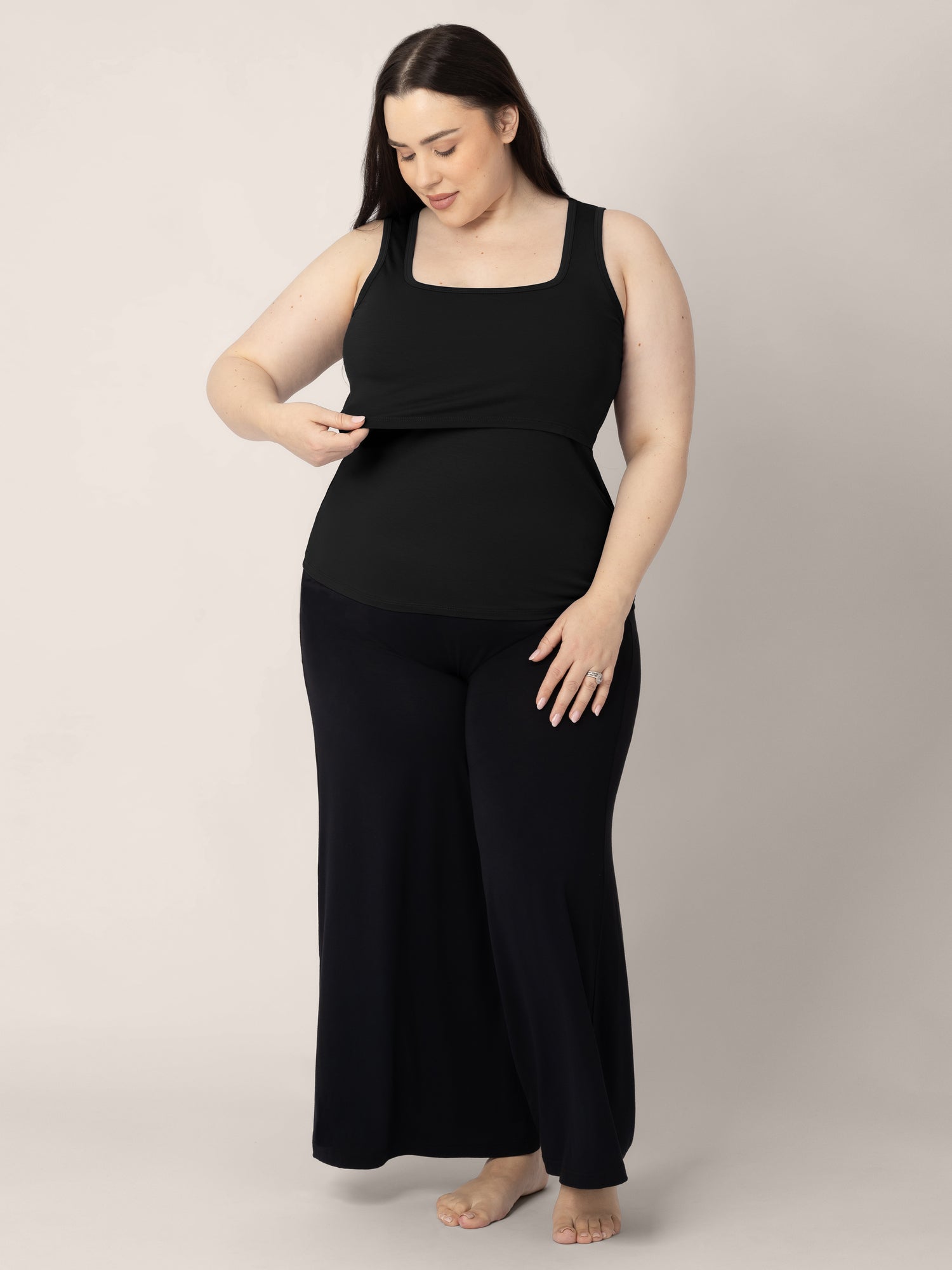 Full body view of a model wearing the Everyday Essential Nursing Tank in Black