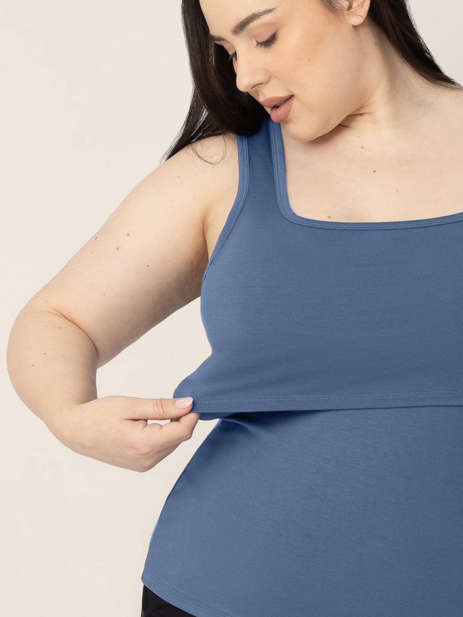 Front view of a model wearing the Everyday Essential Nursing Tank in Slate Blue showing the pull aside nursing panel 