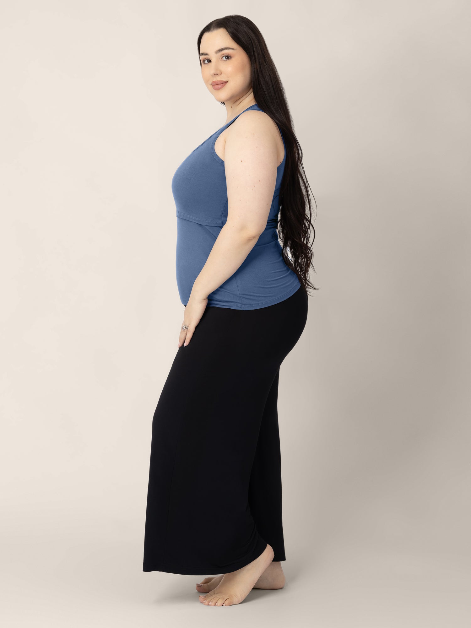 Side view of a model wearing the Everyday Essential Nursing Tank in Slate Blue 