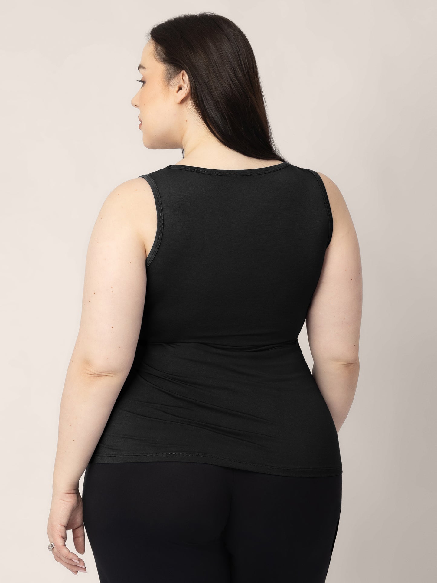 The back view of a model wearing the Everyday Essential Nursing Tank in Black