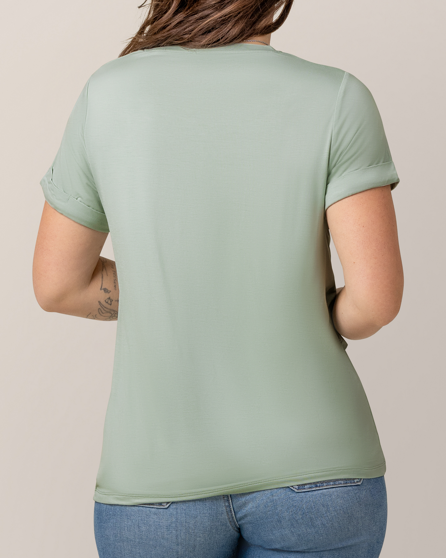 Back view of model wearing the Everyday Asymmetrical Nursing T-shirt in Aqua Mist