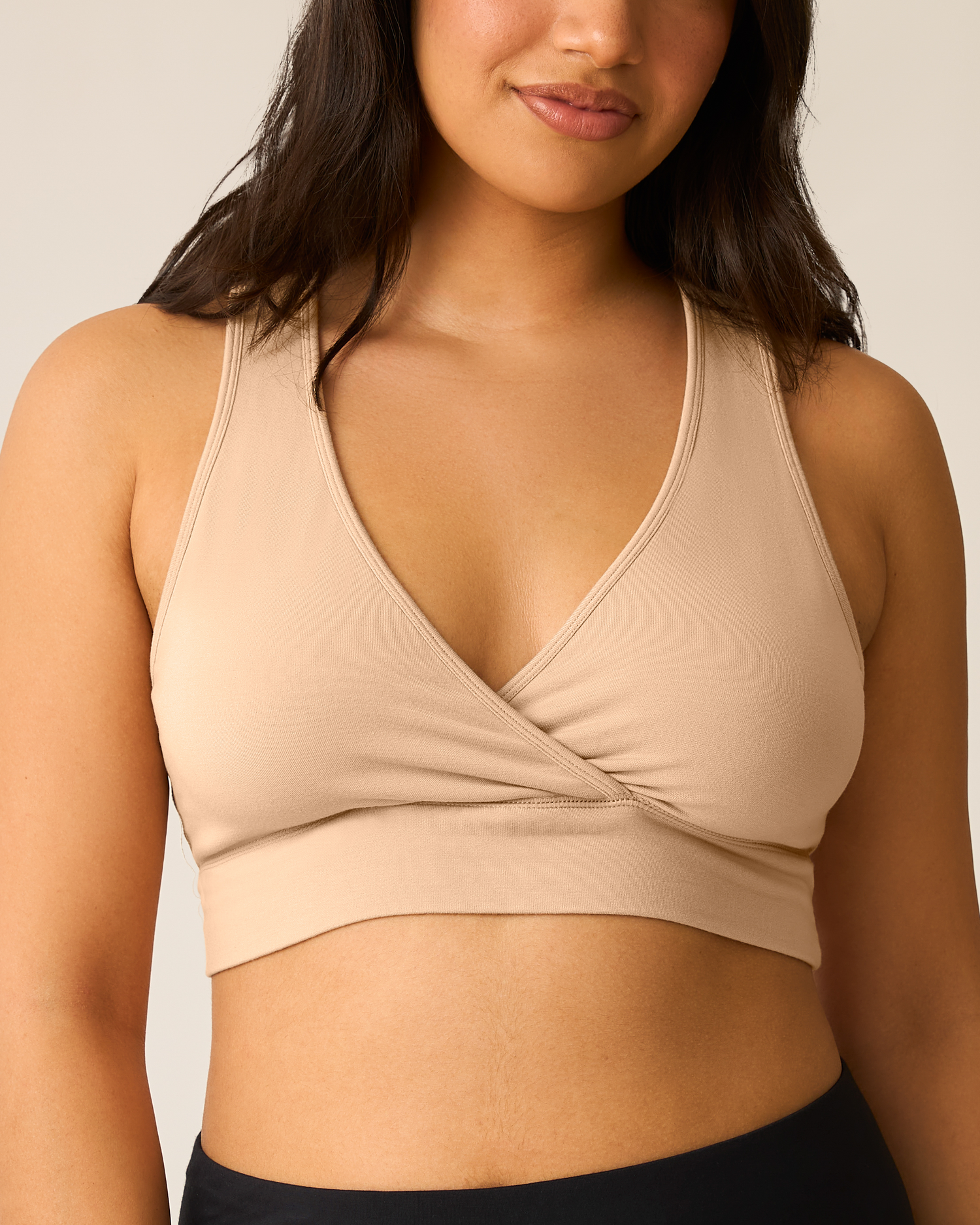 French Terry Racerback Nursing & Sleep Bra in beige worn by a woman on a plain background