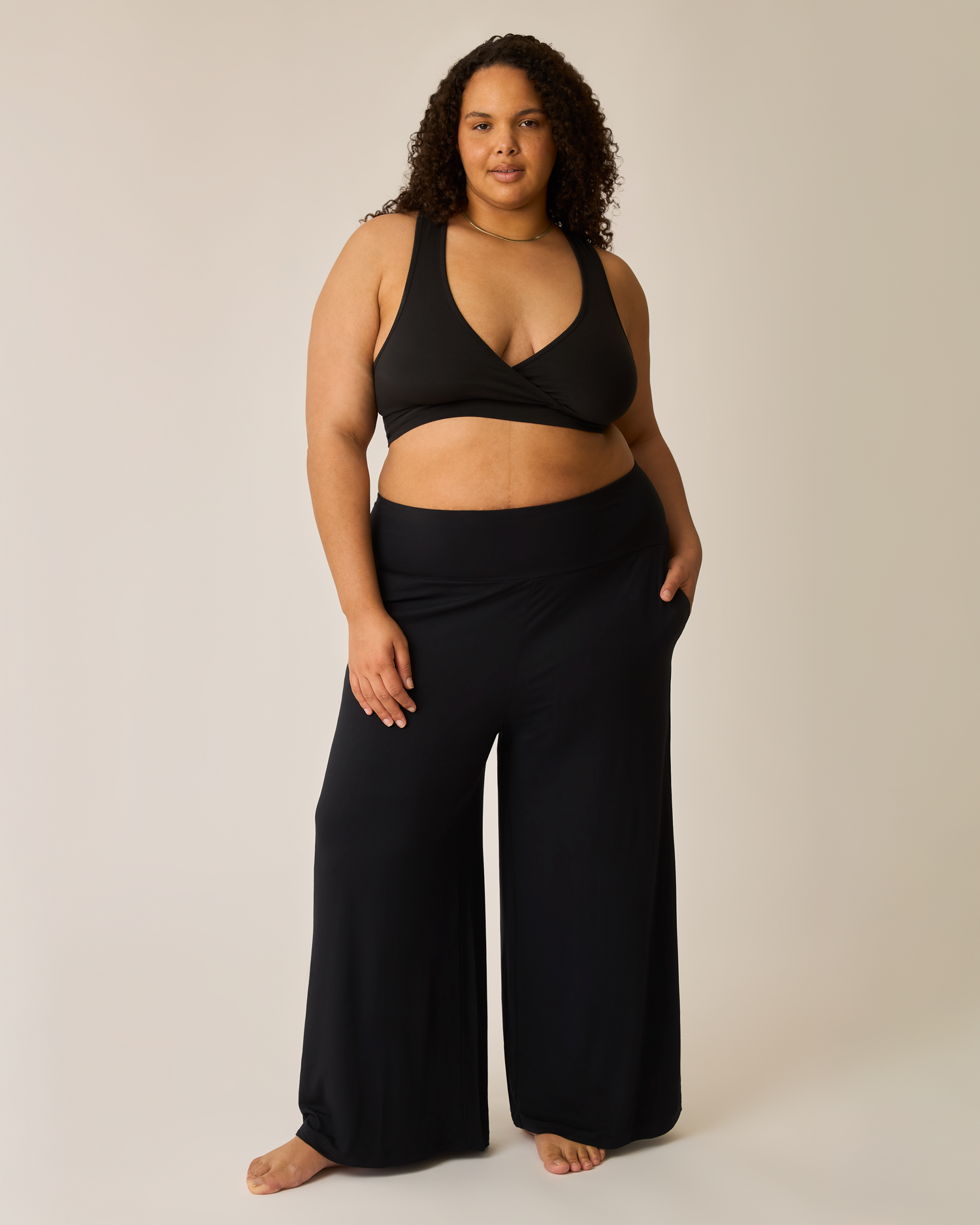 Woman wearing the Bamboo Wide Leg Maternity & Postpartum Lounge Pant in black paired with matching French Terry bra@model_info:Ionna is 5'11" and wearing a 1X Long.