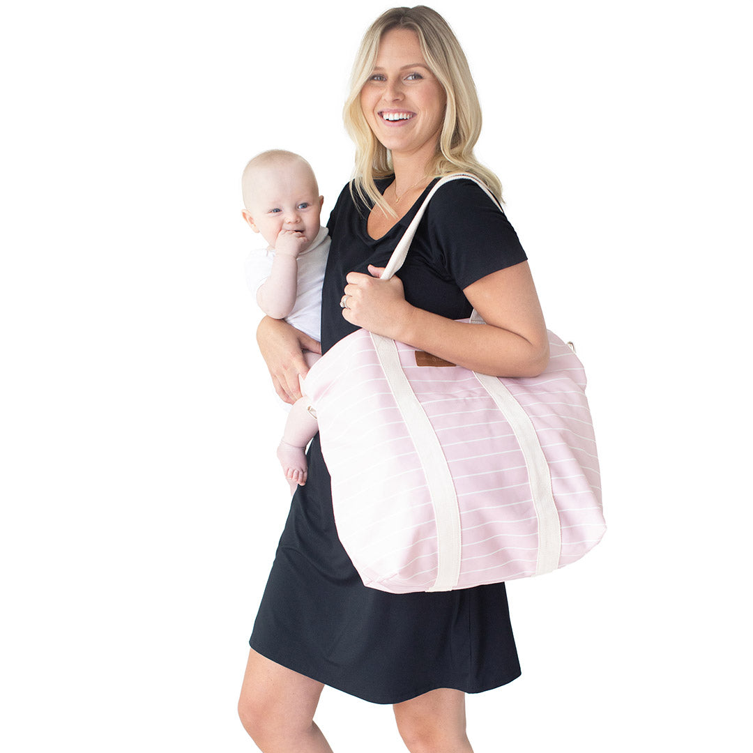 Model holding the Florence Tote in Pink & White Stripe and her baby.