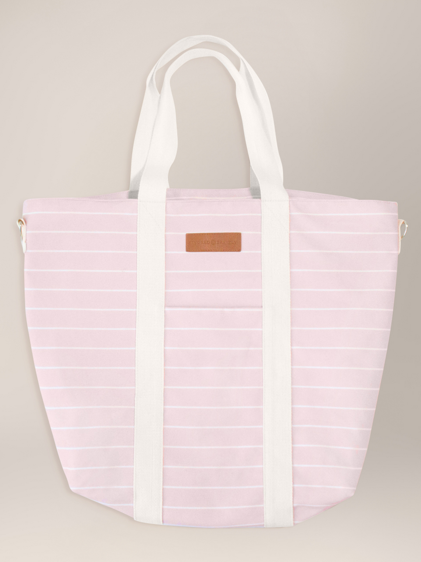 Flat lay of the Florence Tote in Pink & White Stripe against a beige background.