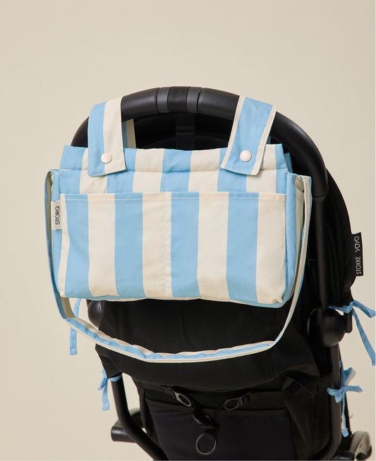 Stroller Party Caddy Bag in Blue Wide Stripe pattern attached to the back of a stroller