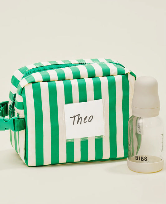 Mini Cooler Bag in the Green Stripe print with a name tag on beige background