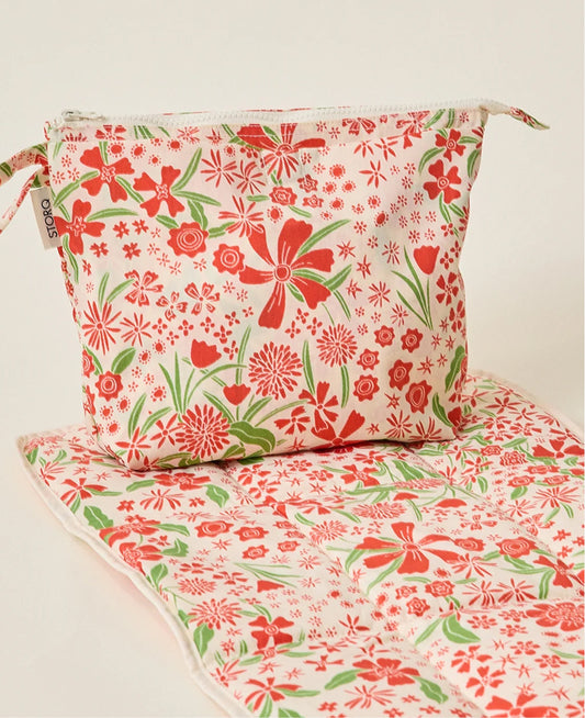 Quick Change Kit Bag and mat in Superbloom on a beige background