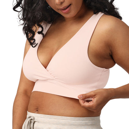 Model holding onto the band of the French Terry Racerback Nursing & Sleep Bra in Soft Pink