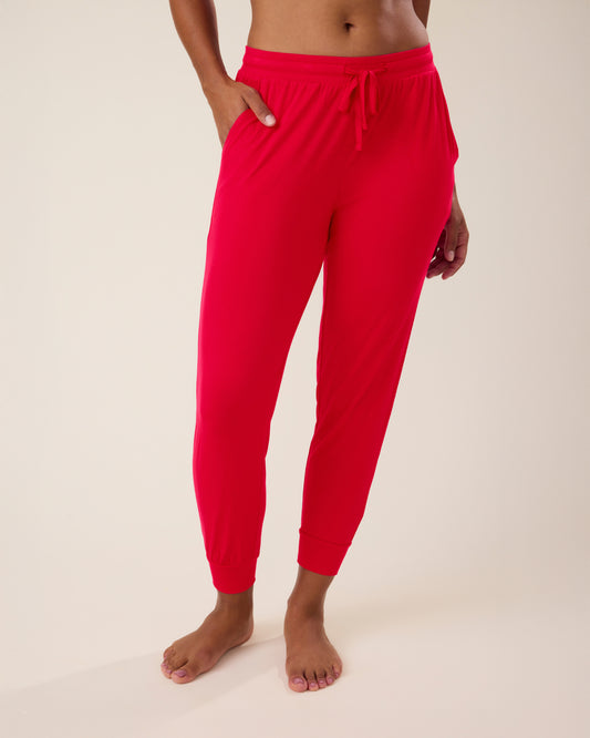 Woman wearing the Everyday Lounge Jogger in red@model_info:Nemesis is 5'9" and wearing a Small.