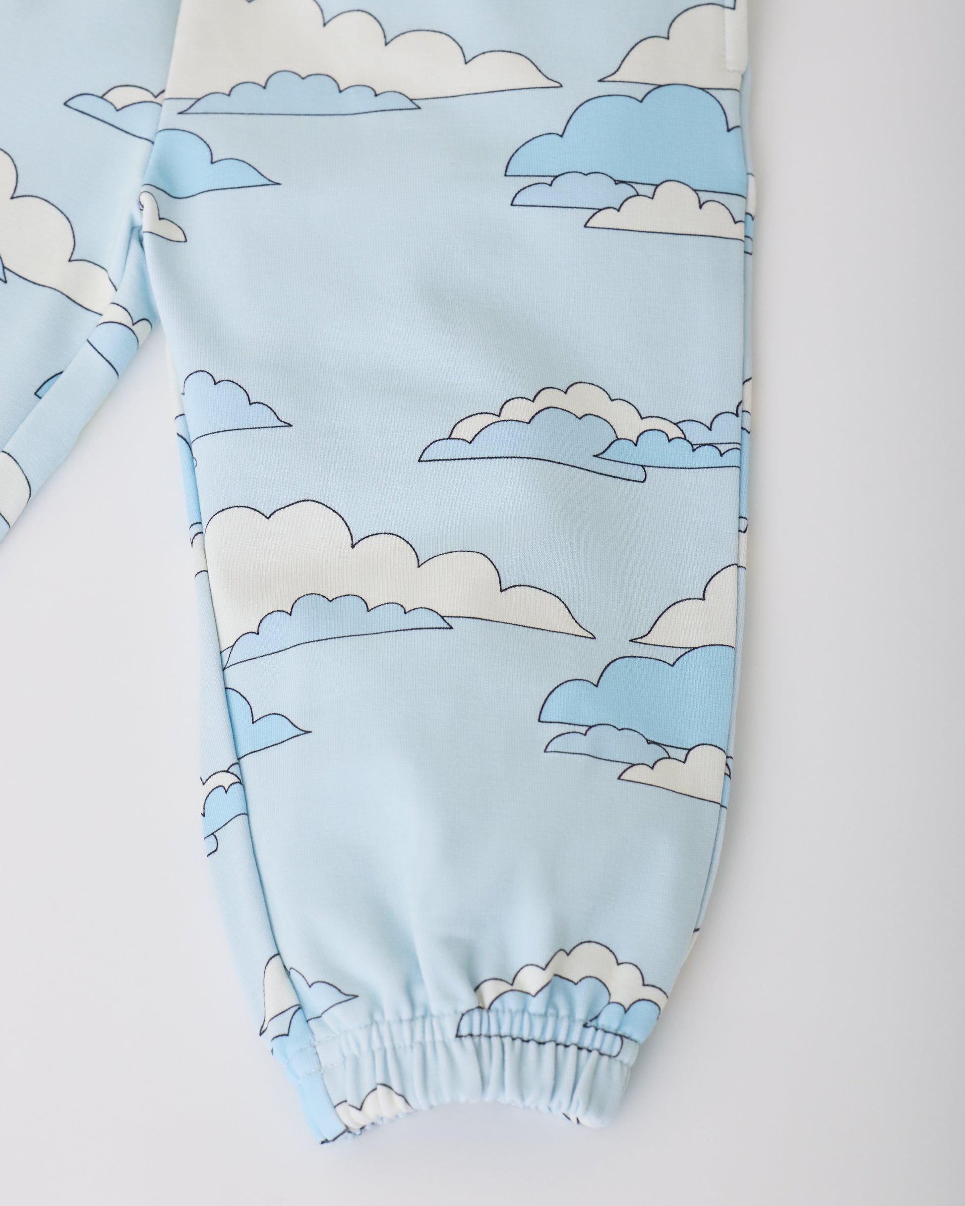 Close up of French Terry Jogger in Blue Clouds on a gray background.