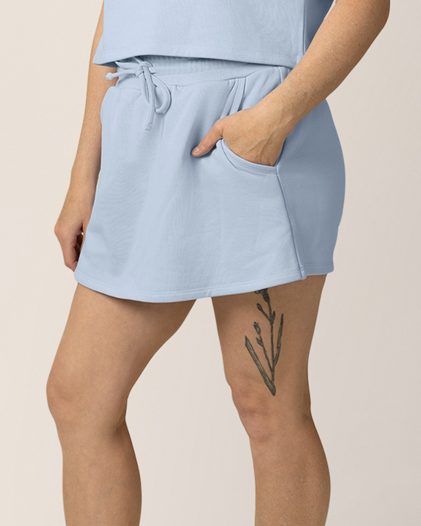 Model wearing French Terry On the Go Skort in French Blue, with hand in pocket