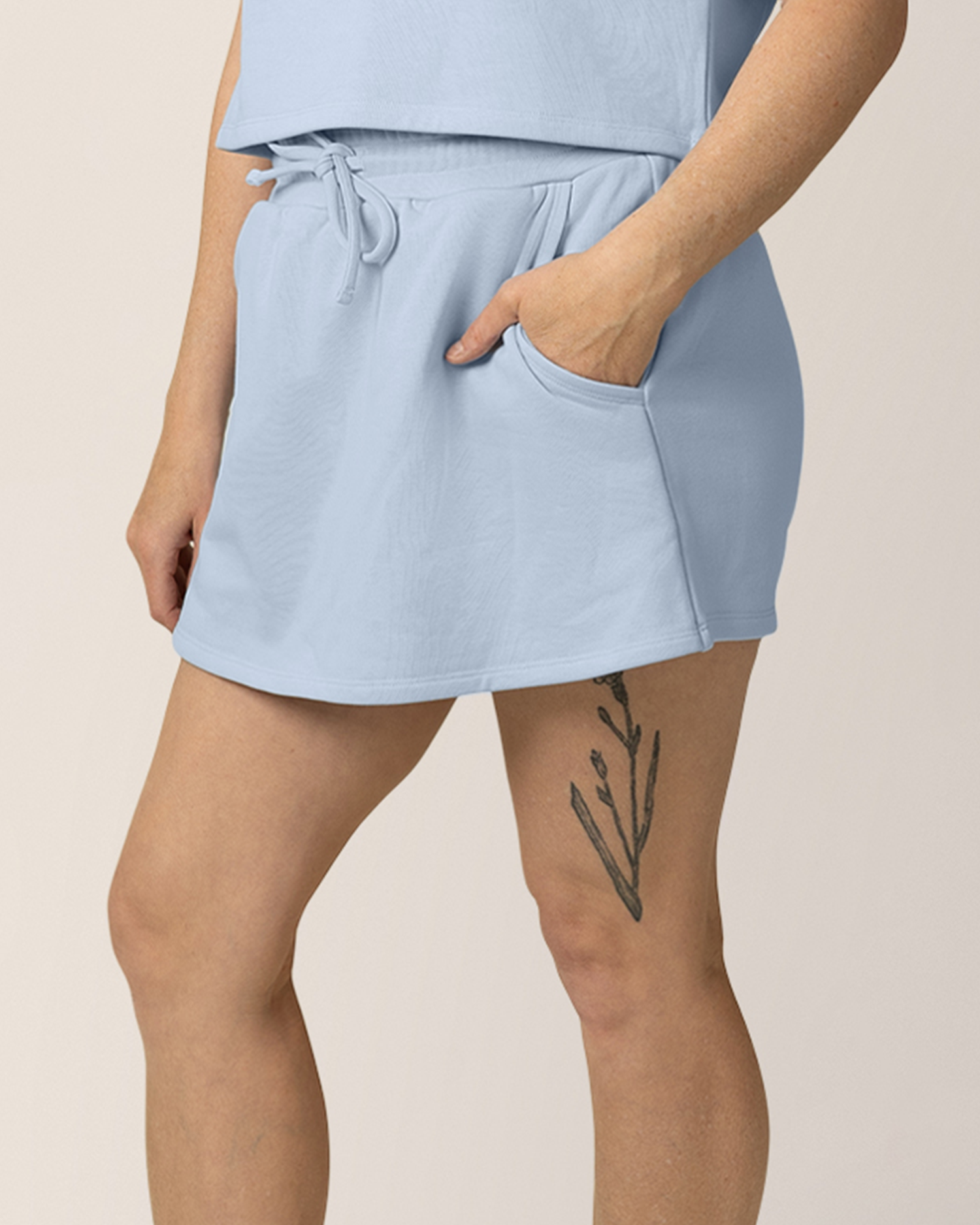 Model wearing French Terry On the Go Skort in French Blue, with hand in pocket