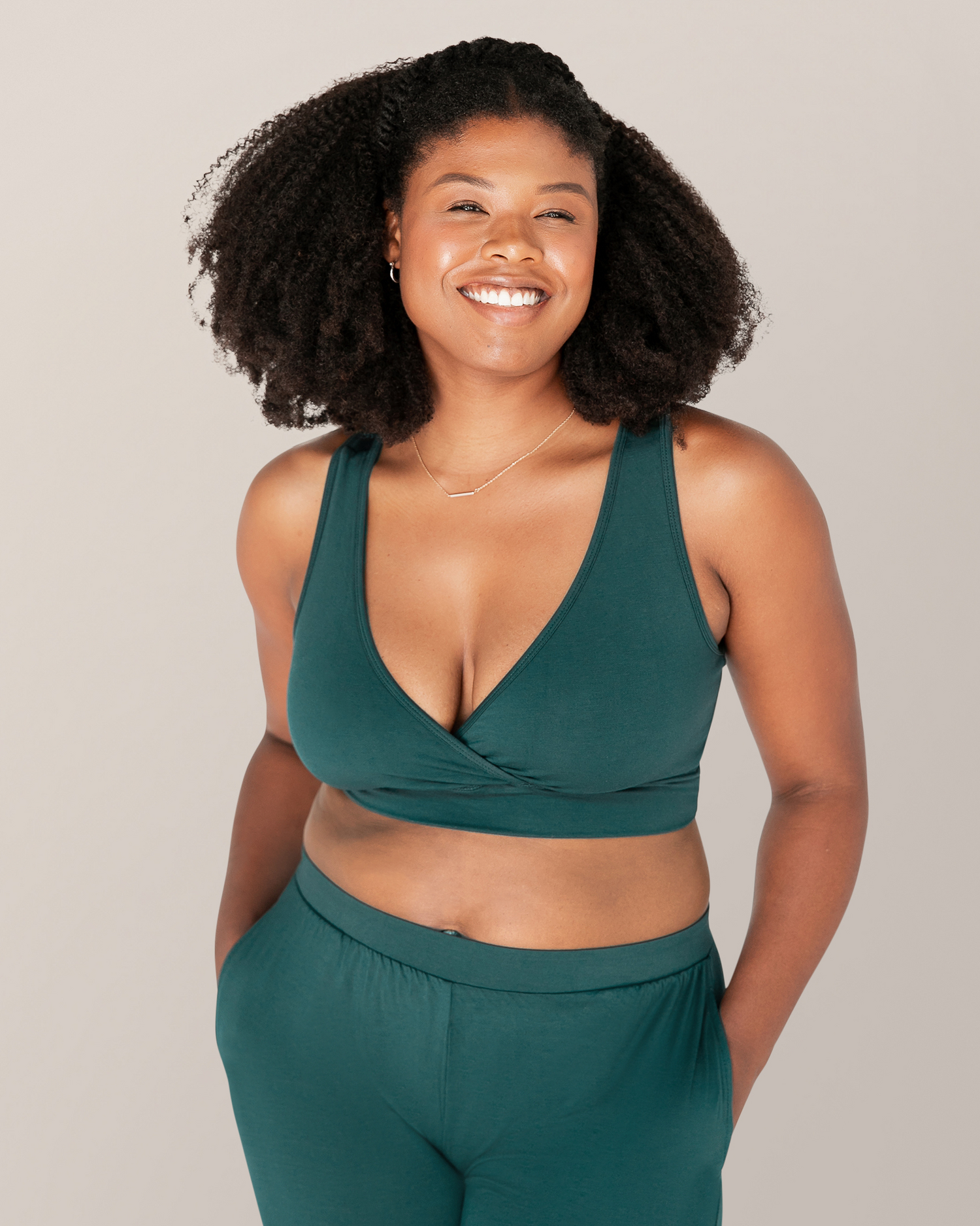 Front view of model outside wearing the French Terry Racerback Nursing & Sleep Bra in Evergreen@model_info:Joy is wearing a Medium.