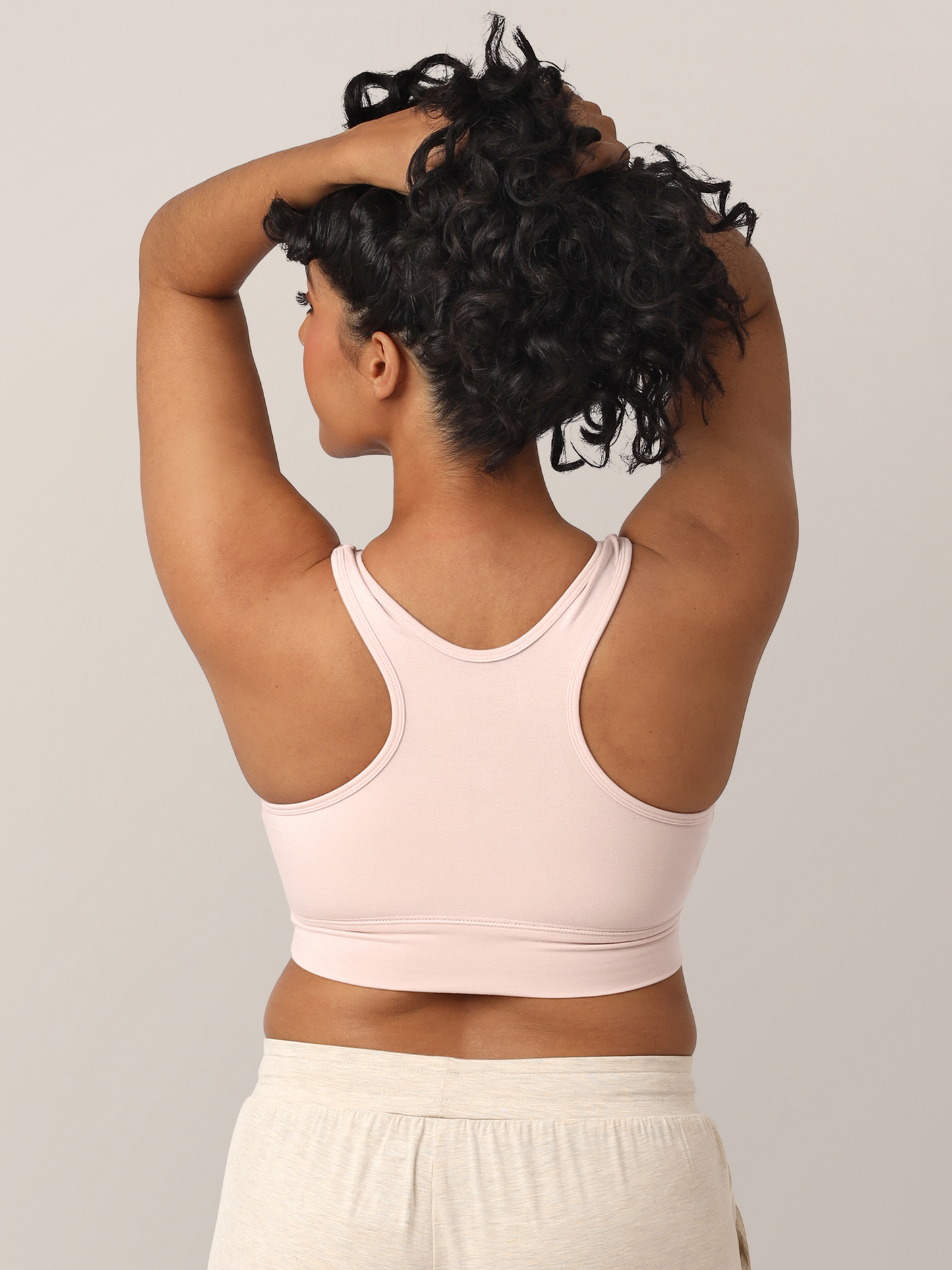 Back view of model wearing the French Terry Nursing Bra in Soft Pink showing off the racerback. 