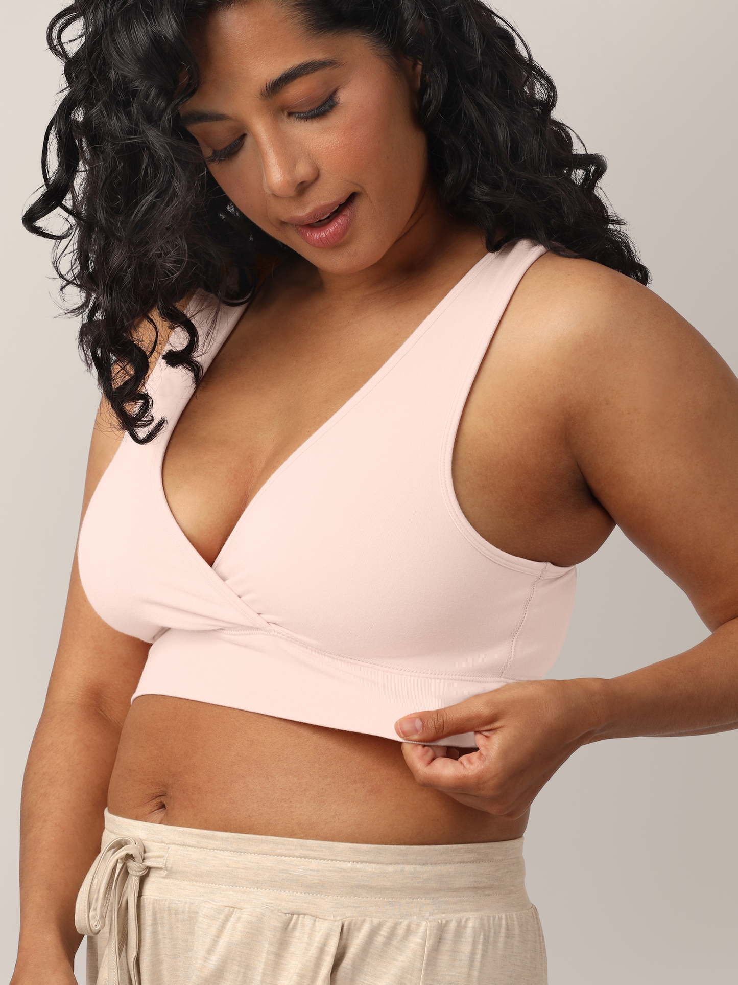 Detailed zoomed in shot of model wearing the French Terry Nursing Bra in Soft Pink showing the stretch in the waistband. 