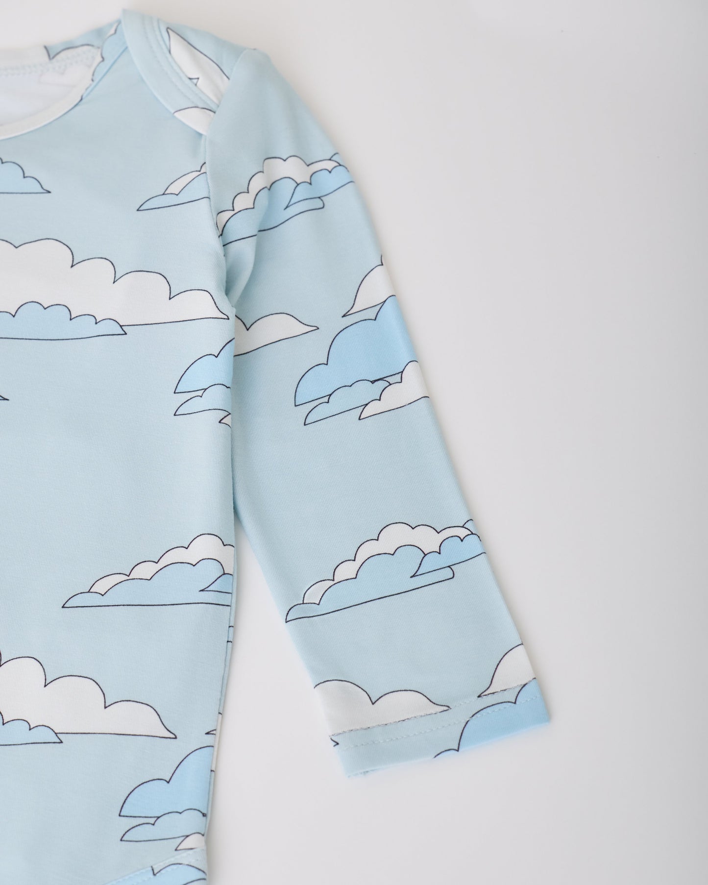 Close up of sleeve on Blue Clouds of Long Sleeve Bamboo Onesie Two-Pack in Clouds on a white background.