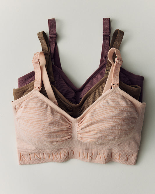 Sublime® Hands-Free Pumping & Nursing Bras in Pink Heather, Latte and Twilight. Build Your Own Wash Wear Spare Sleeping Pumping Bra Bundle on a beige background.