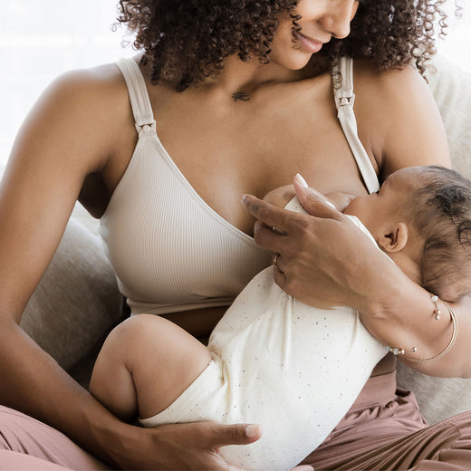 Woman breastfeeding a baby in the Mia Bra